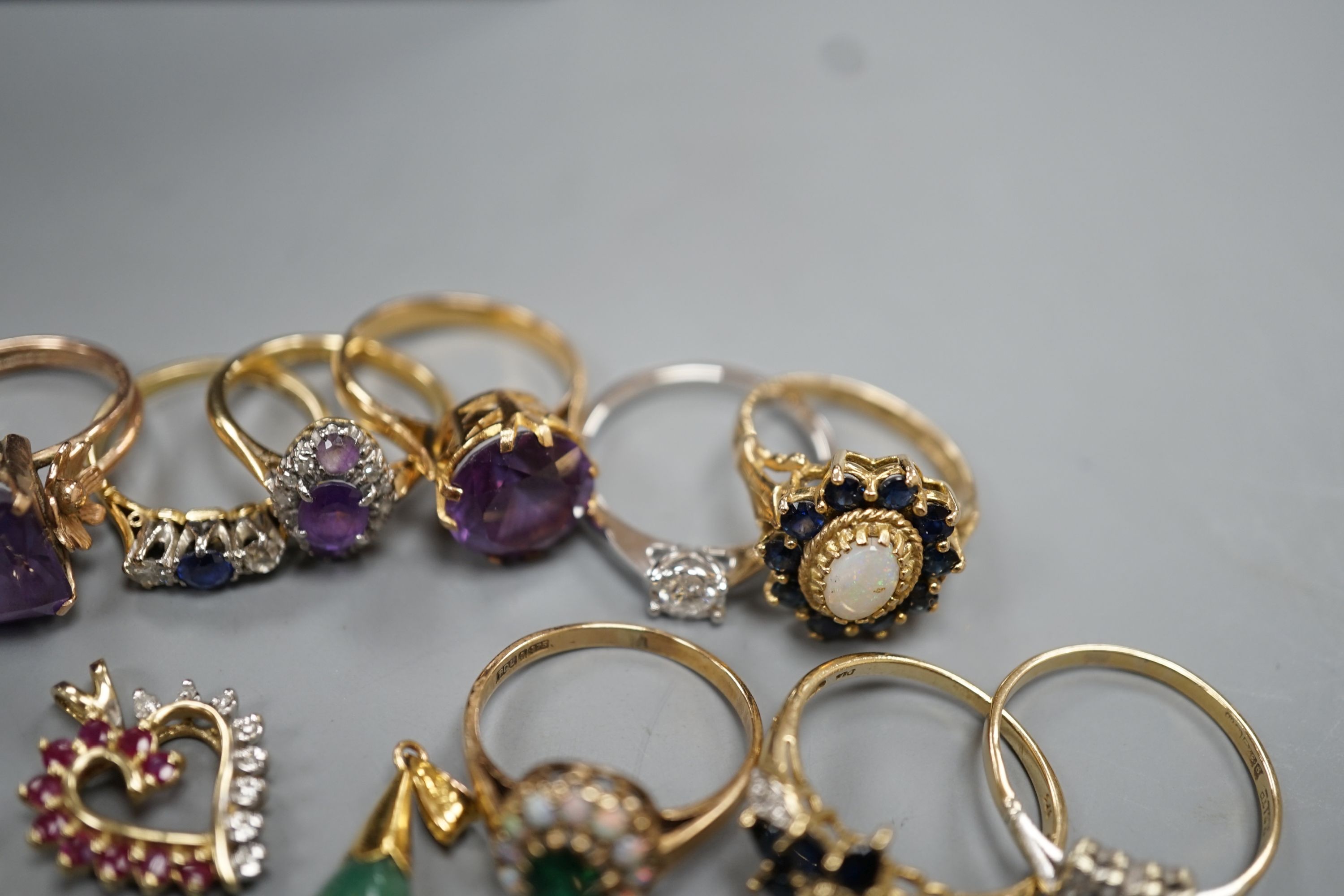 Two 18ct and gem set rings, including amethyst and diamond, size K and sapphire and diamond three stone, size J/K, gross 5.5 grams, four 9ct and gem set rings and two 9ct and gem set pendants, gross 19.9 grams, two yello